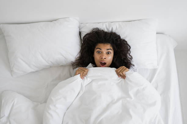 istock Afro american woman with shocked face looking at camera 1360684973