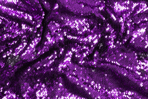 istock Bright violet sequins background - abstract festive backdrop for Holiday and party banner. Glamour shiny background with sequin texture and blinking lights. Sequins fabric purple color 1360686277
