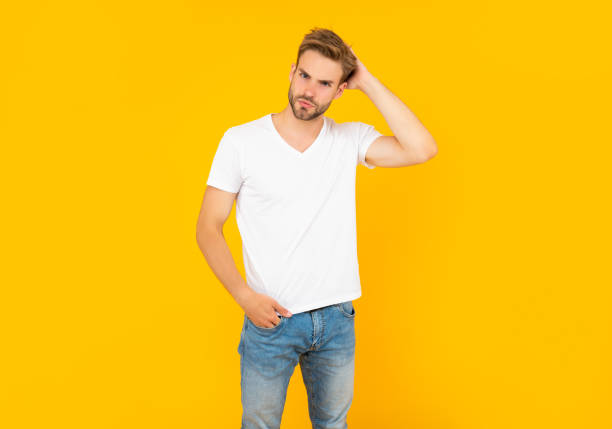 istock sexy guy with bristle on yellow background, casual 1360687058