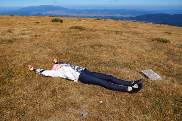 istock girl resting in the mountains lying on the ground 1360689029