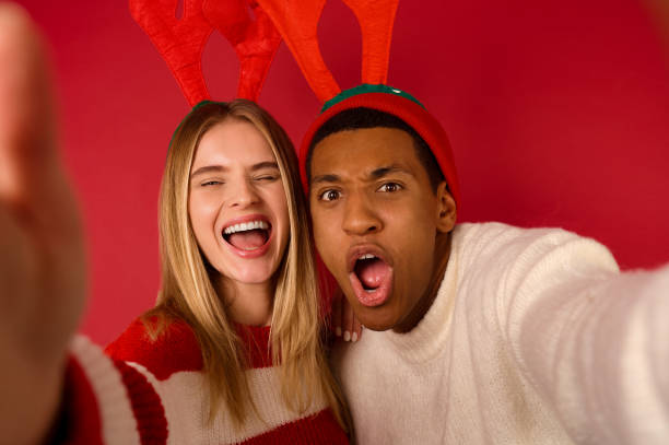 istock A young couple in horned hats having fun 1360689062