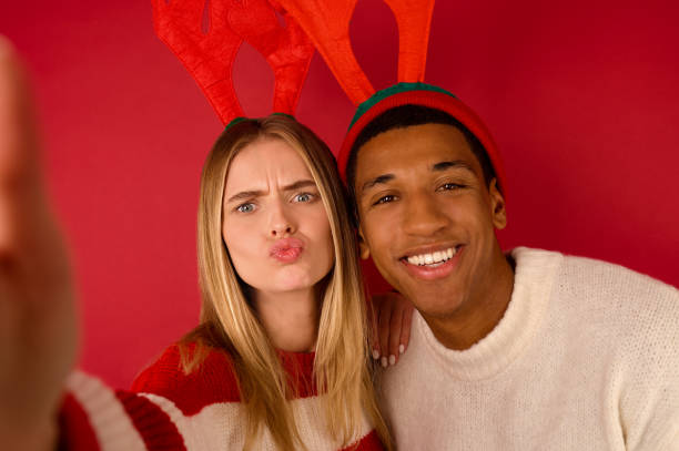 istock A young couple in horned hats having fun 1360689064