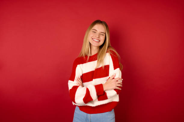 istock A cute young girl in a red and white sweater 1360689163