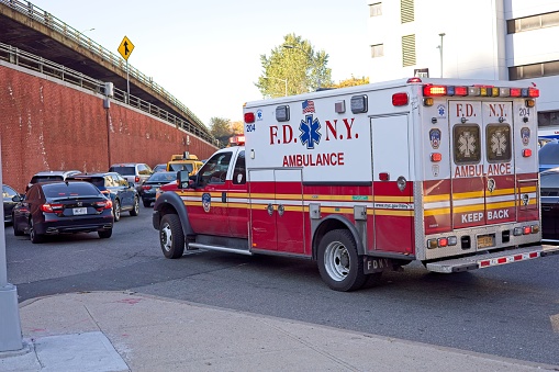Brooklyn, NY, USA - Dec 24, 2021: An ambulance from the Fire Dept of New York heads onto the Brooklyn Queens Expressway