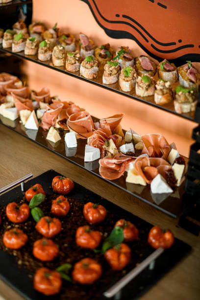 istock Beautiful view on various types of appetizers on plates. 1360689928