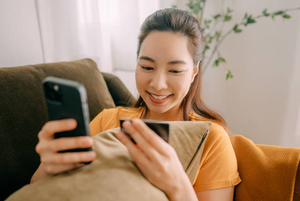 istock Young woman Using credit card payment 1360690263