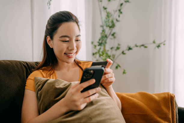 istock Young woman Using credit card payment 1360690278