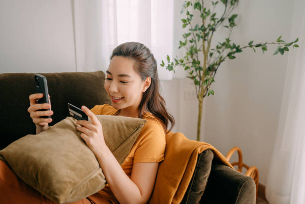 istock Young woman Using credit card payment 1360690301