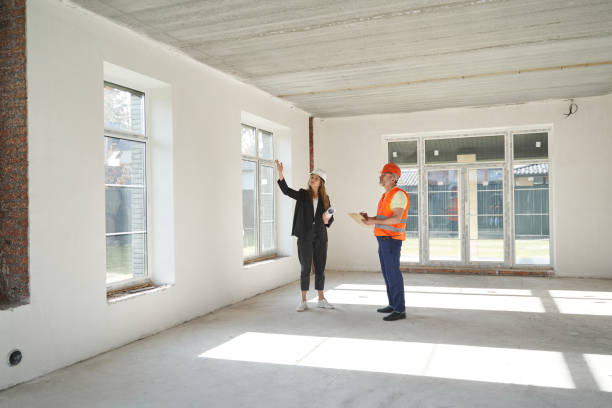 istock Woman engineer pointing hand at upper part of window 1360691309