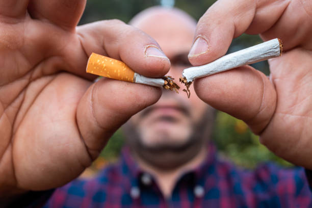 istock man breaking a cigarette in front of the camera 1360698330