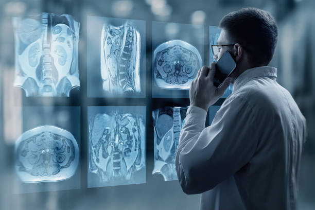 Doctor looking at x-rays on a virtual computer screen . stock photo
