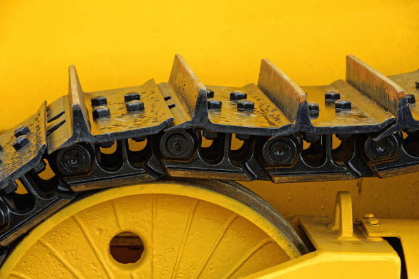 Track drive gear, bulldozer sprocket mechanism, large yellow construction machine with bolts, heavy industry, detail