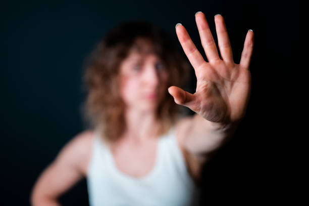 istock Young woman showing STOP sign with her palm 1360701432
