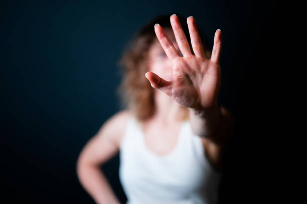 istock Young woman showing STOP sign with her palm 1360701448