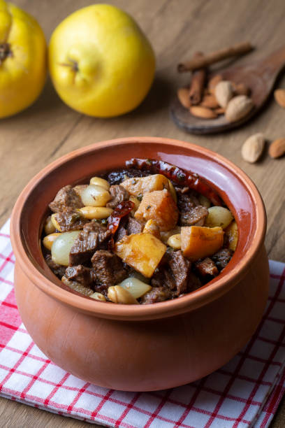 traditional delicious turkish foods; quince and plum lamb stew, lamb tandoori (turkish name; ayvali - erikli kuzu guvec - kuzu tandir - lamb shank dinner meal imagens e fotografias de stock