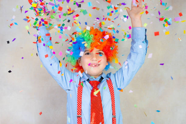 istock Funny kid with necktie and wig at Carnival 1360705551