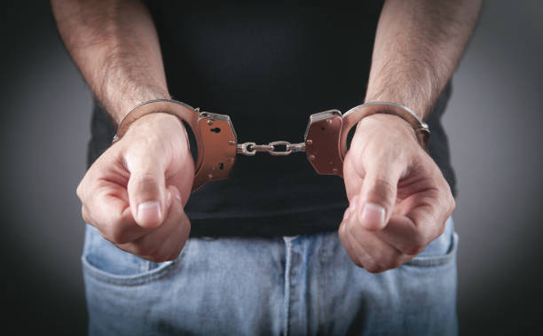 istock Caucasian male hands in handcuffs. Arrest 1360706629