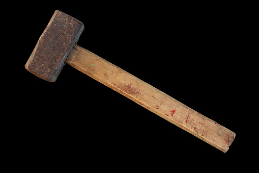 An old large sledgehammer with a wooden handle. Hammer. Close-up. Horizontal side view. The isolated object on a black background. Isolate.