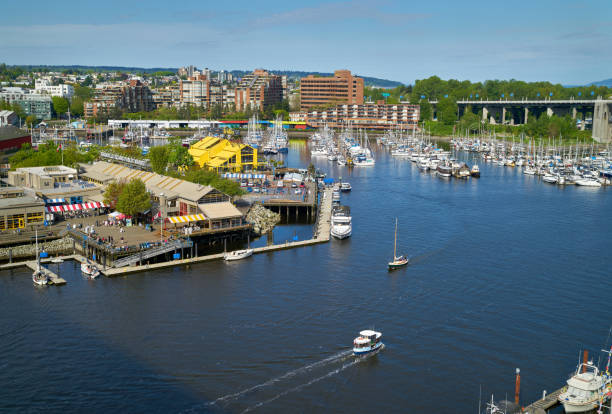 Granville Island Market on False Creek A busy False Creek and Granville Island on a sunny afternoon. Vancouver,
British Columbia, Canada. May 6, 2018. granville island stock pictures, royalty-free photos & images