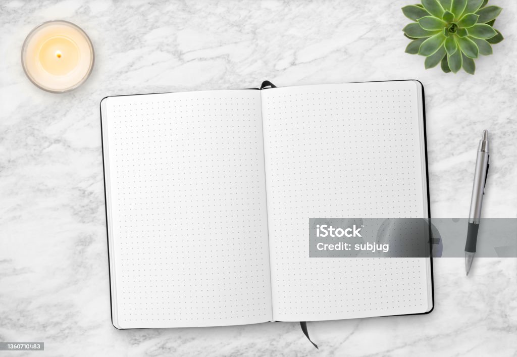 Marble table top with bullet journal Marble table top with bullet journal, a candle, a pen and a succulent plant Bullet Journal Stock Photo