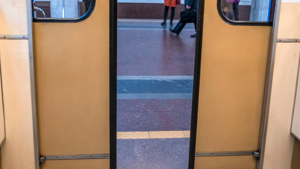 istock Subway train with opened doors on platform. Metal doors on the train. Wagons of subway in underground. 1360711908