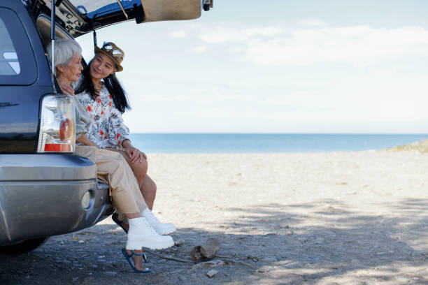 istock Women camping in van at the beach 1360717467