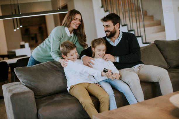 istock Siblings fighting over TV remote control at home 1360717537