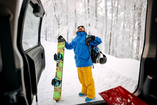 Man on the mountain is ready to snowboard