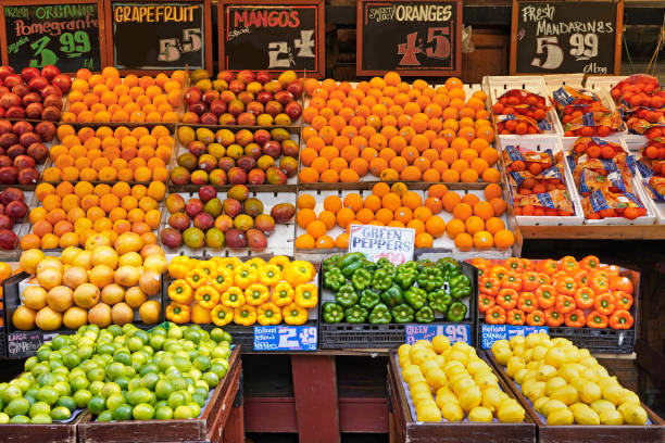 Outdoor fruit and vegetable display on table on sidewalk outside a grocery store