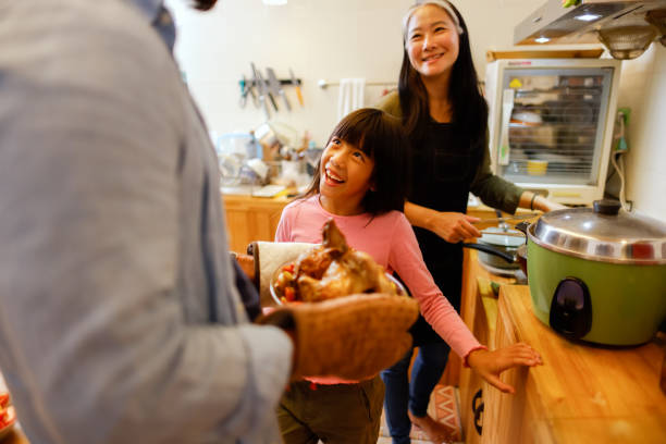 istock Father taking the dinner out of the oven 1360720418