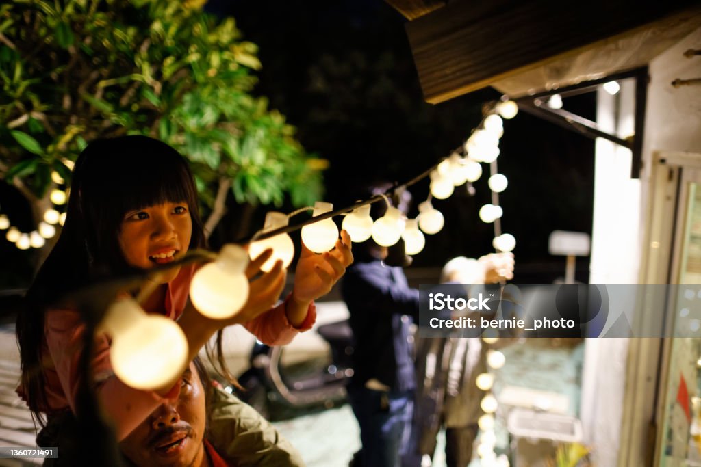 Decorate Christmas lights with my family Decorate Christmas lights with my family in the evening Decorating Stock Photo