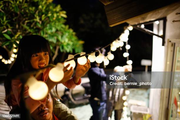 Decorate Christmas Lights With My Family Stock Photo - Download Image Now - Decorating, House, Outdoors