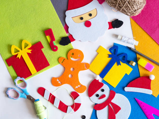 istock Hobby and colorful felt crafts. Workspace view. Sheets and crafts made of felt, scissors, threads and a needle for needlework. 1360724496