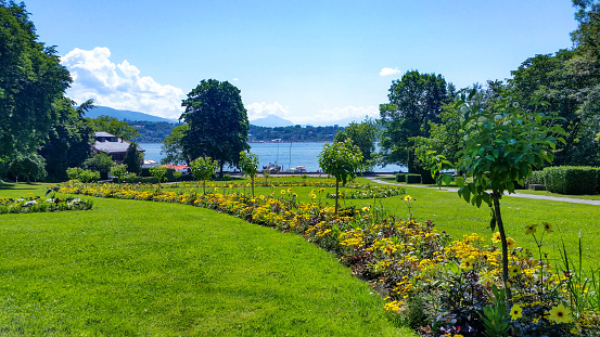 A Peaceful Scene in Switzerland looking from a public garden to the lake