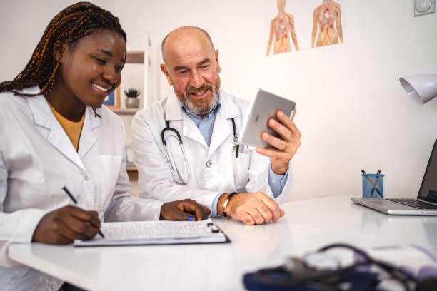istock Two co-working doctors looking at medical charts on digital tablet 1360731934