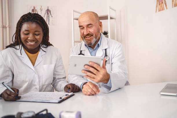 istock Two co-working doctors looking at medical charts on digital tablet 1360731943