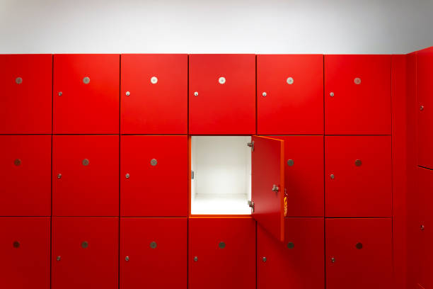 deposit red locker boxes or gym lockers inside of a room with one central opened door - wide screen imagens e fotografias de stock