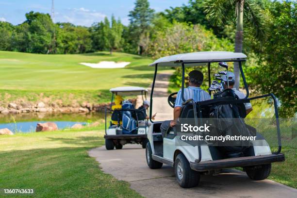 Group Of Asian Senior Man Driving Golf Cart On Golf Course In Summer Sunny Day Stock Photo - Download Image Now
