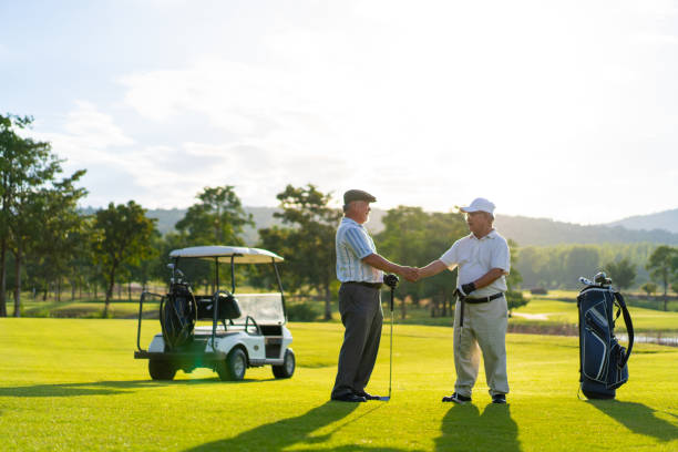 istock Asian senior man shaking hand at golf course. 1360744284