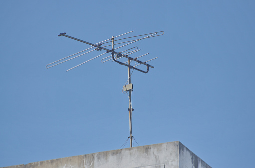 Old TV antenna installed on the roof of the building.