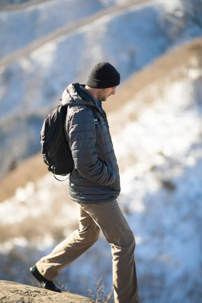 istock Rugged mountain man enjoying winter mountain hiking 1360753296