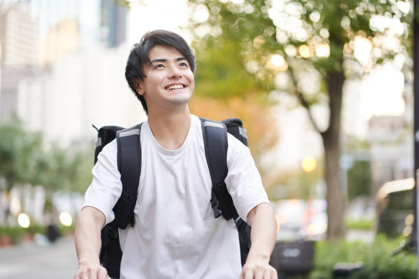 istock Asian man delivering food outside 1360753363