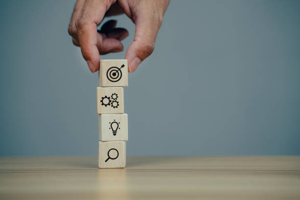 istock Hands holding woods block step on table with icon business strategy 1360756575
