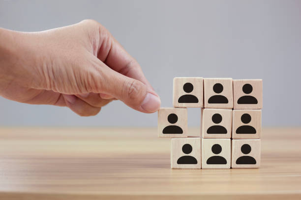 istock Man hands holding cube with many human symbol 1360756673