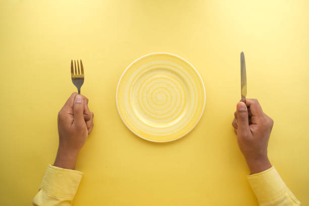 istock cutlery and empty plate on wooden background top down 1360758060