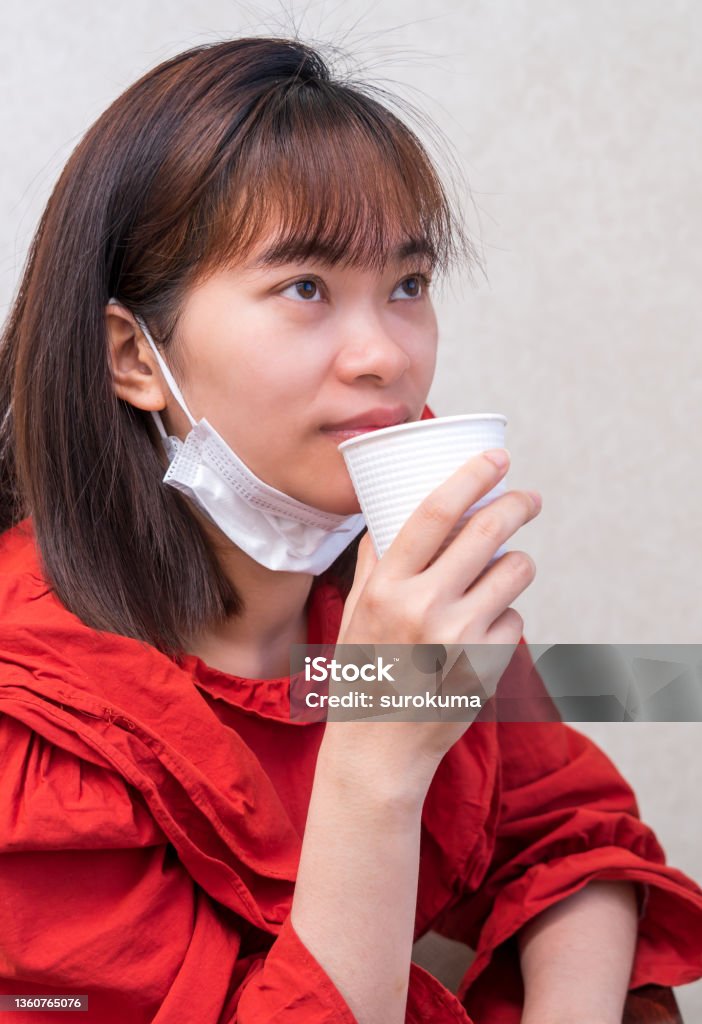 Young woman eating with mask. new normal in covi-19 portrait Adult Stock Photo