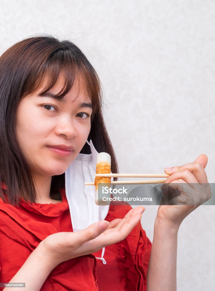 Young woman eating with mask. new normal in covi-19 portrait Adult Stock Photo