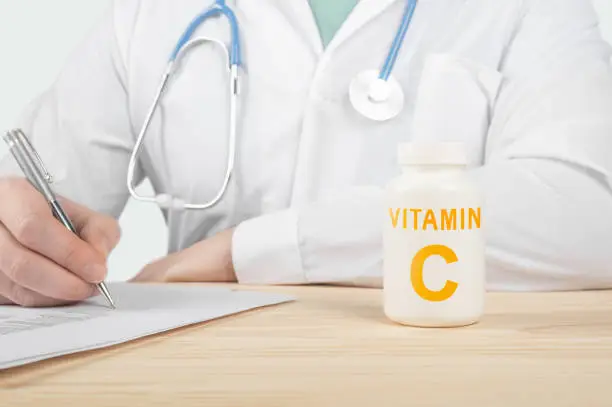Vitamin C and supplements for human health. Doctor recommends taking vitamin C. doctor talks about Benefits of vitamin C. Essential vitamins and minerals for humans. C Vitamin Health Concept.
