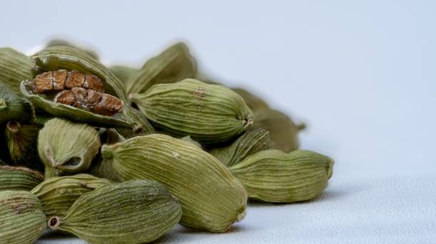 istock Dried cardamom seeds isolated on white 1360772105