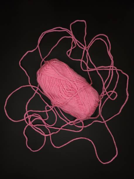 The pink yarn on the background.